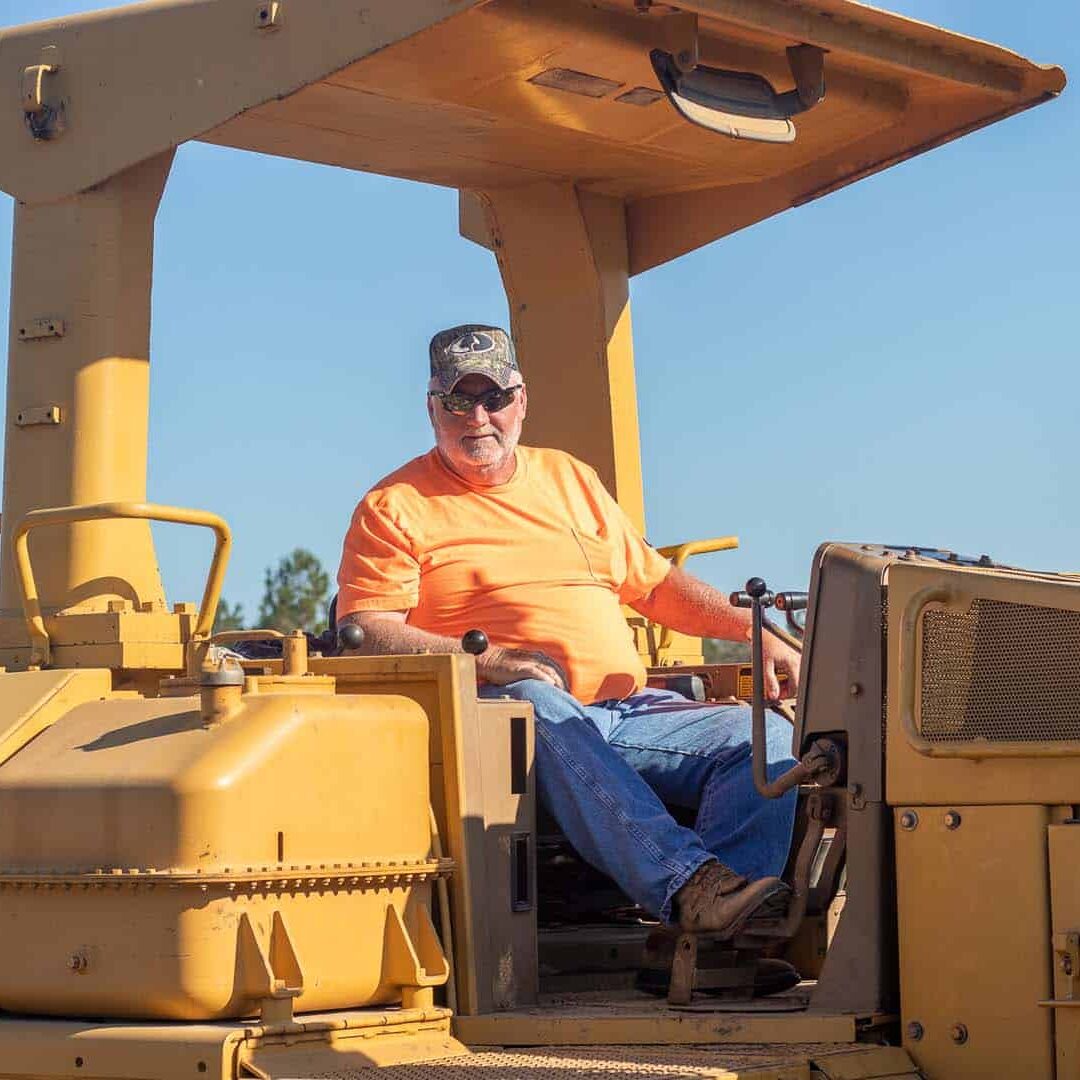 A man driving a bull dozer